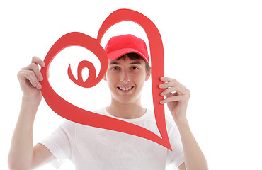 Image showing Teen looking through a red love heart