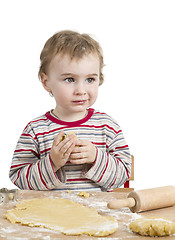 Image showing happy young child with rolling pin in white background