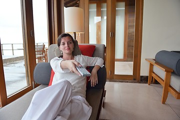 Image showing happy young woman relax at home on sofa