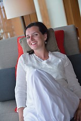 Image showing happy young woman relax at home on sofa