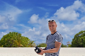 Image showing photographer taking photo on beach