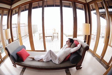 Image showing happy young woman relax at home on sofa