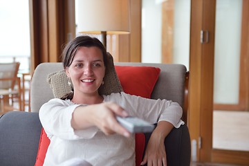 Image showing happy young woman relax at home on sofa