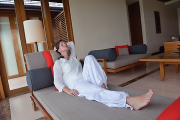 Image showing happy young woman relax at home on sofa