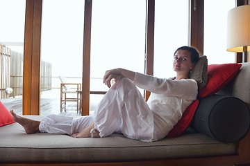 Image showing happy young woman relax at home on sofa