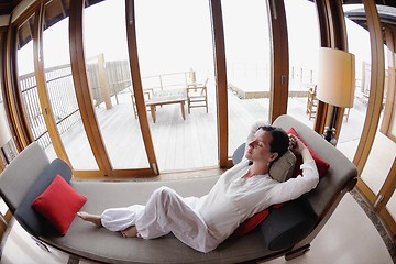 Image showing happy young woman relax at home on sofa