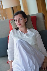 Image showing happy young woman relax at home on sofa