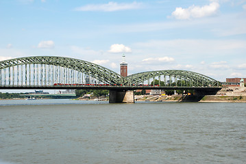 Image showing A train crosses the Hohenzollernbruecke over the Rhine in Cologn