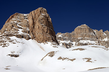 Image showing Rocks in snow and clear blue sky