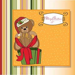 Image showing cute teddy bear with a big Christmas gift box