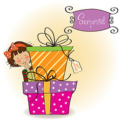Image showing cute little girl hidden behind boxes of gifts. happy birthday gr