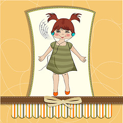 Image showing young girl listening to music on headphones and dancing