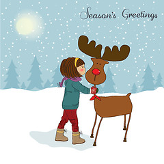 Image showing Christmas card with cute little girl caress a reindeer