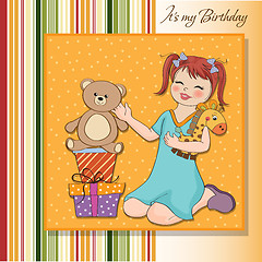 Image showing little girl playing with her birthday gifts . happy birthday car