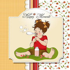 Image showing funny lovely little girl blowing soap bubbles