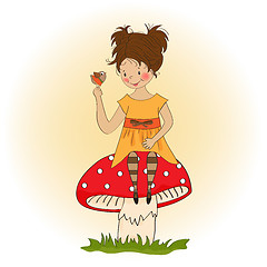 Image showing pretty young girl sitting on a mushroom