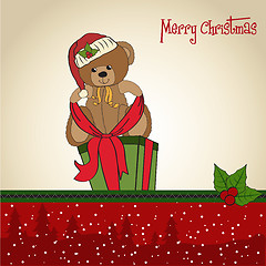 Image showing cute teddy bear with a big Christmas gift box