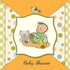 Image showing little baby boy play with his toys. shower card in vector format