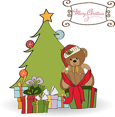 Image showing cute teddy bear with a big Christmas gift box