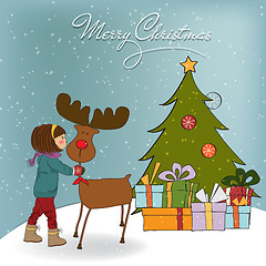 Image showing Christmas card with cute little girl caress a reindeer