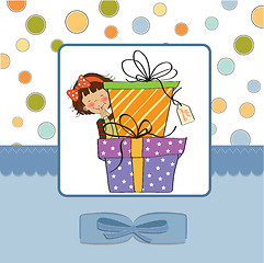 Image showing cute little girl hidden behind boxes of gifts. happy birthday gr