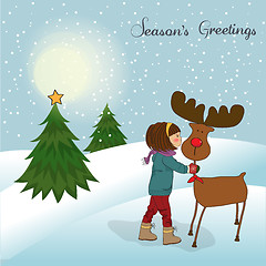 Image showing Christmas card with cute little girl caress a reindeer