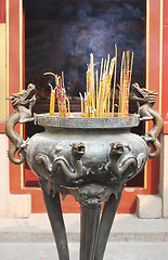 Image showing Burning incense sticks at a temple.