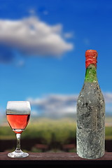 Image showing old red wine and glass