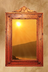 Image showing sunrise seen throung an ancient window