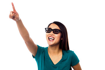 Image showing Jolly female model pointing at something
