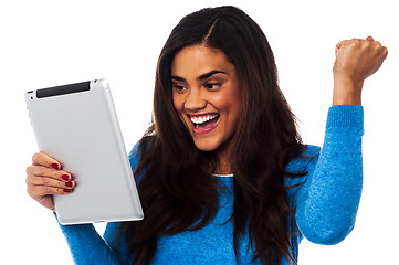 Image showing Excited woman holding touch pad