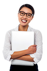 Image showing Female secretary holding laptop tightly