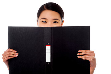 Image showing Chinese woman hiding face with business file