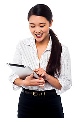 Image showing Corporate woman brwosing on tablet pc