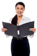 Image showing Female assistant reviewing file