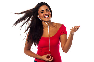 Image showing Cheerful girl enjoying music madly