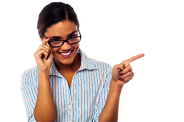 Image showing Woman adjusting her spectacles and pointing away