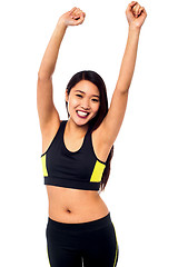 Image showing Joyous female raising arms in excitement