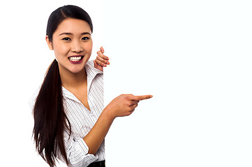Image showing Business lady pointing towards ad on billboard