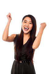 Image showing Excited woman with clenched fists