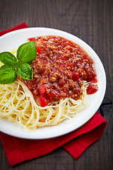 Image showing Spaghetti bolognese and green basil leaf on white plate