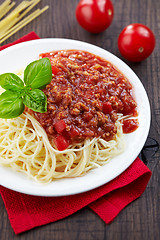 Image showing Spaghetti bolognese and green basil leaf on white plate