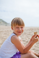 Image showing Happy girl with ice cream on beach