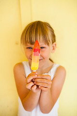 Image showing Young girl holding up popsicle