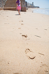 Image showing Young girl walking on beach