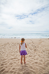 Image showing Young girl standing at beach