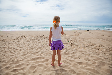 Image showing Young girl standing at beach