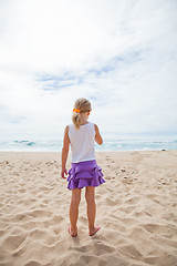 Image showing Young girl standing at beach