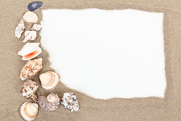 Image showing sea shells with sand and white paper as background 