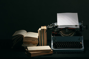 Image showing Old typewriter with books retro colors on the desk